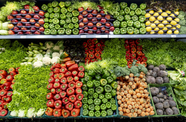 Delicious fresh vegetables and fruits at the refrigerated section of a supermarket