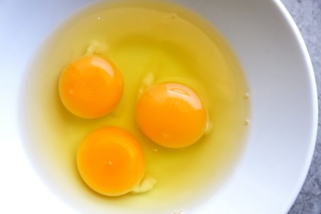 Yolk eggs in white bowl
